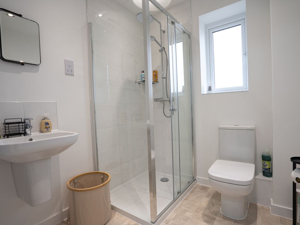 A bathroom with a shower, toilet, and sink at Peak Avenue Retreat in Wingerworth near Chesterfield