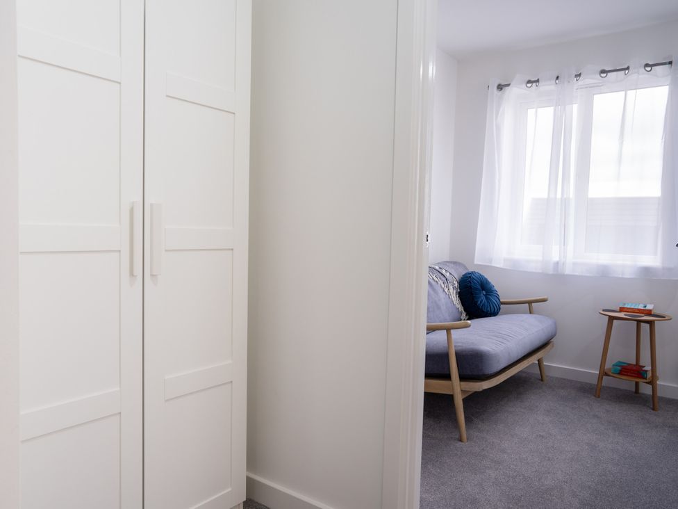 A living room with a sofa and a wardrobe at Peak Avenue Retreat in Wingerworth near Chesterfield