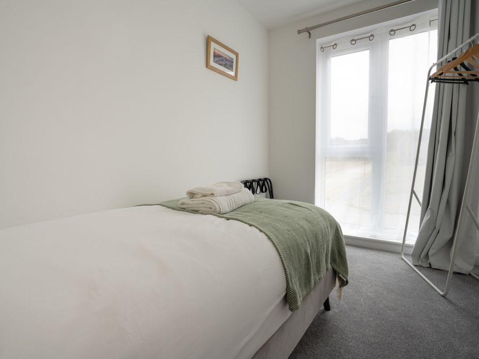 A bedroom with a bed and towels at Peak Avenue Retreat in Wingerworth near Chesterfield