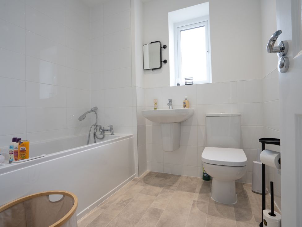 A bathroom with a bathtub and a sink at Peak Avenue Retreat in Wingerworth near Chesterfield