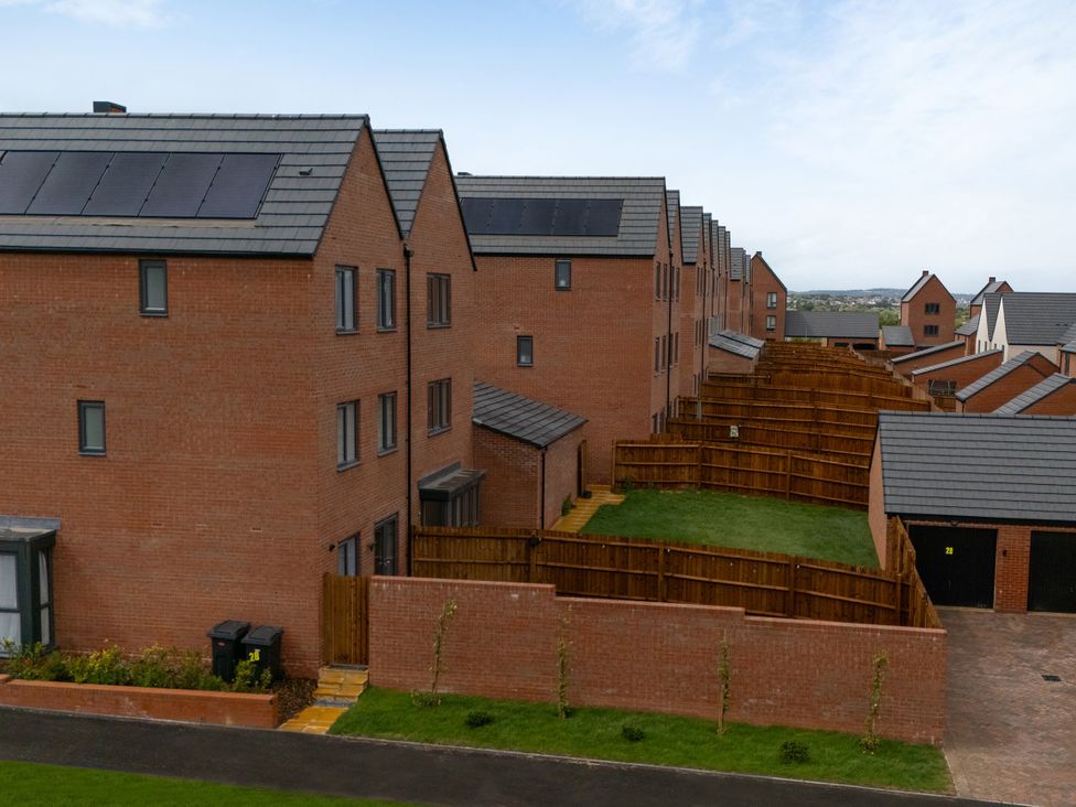 A row of houses with fences and solar panels at Peak Avenue Retreat in Wingerworth near Chesterfield