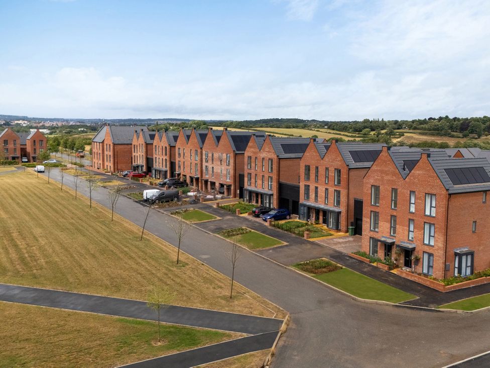 A row of houses with a driveway and grass area at Peak Avenue Retreat in Wingerworth near Chesterfield