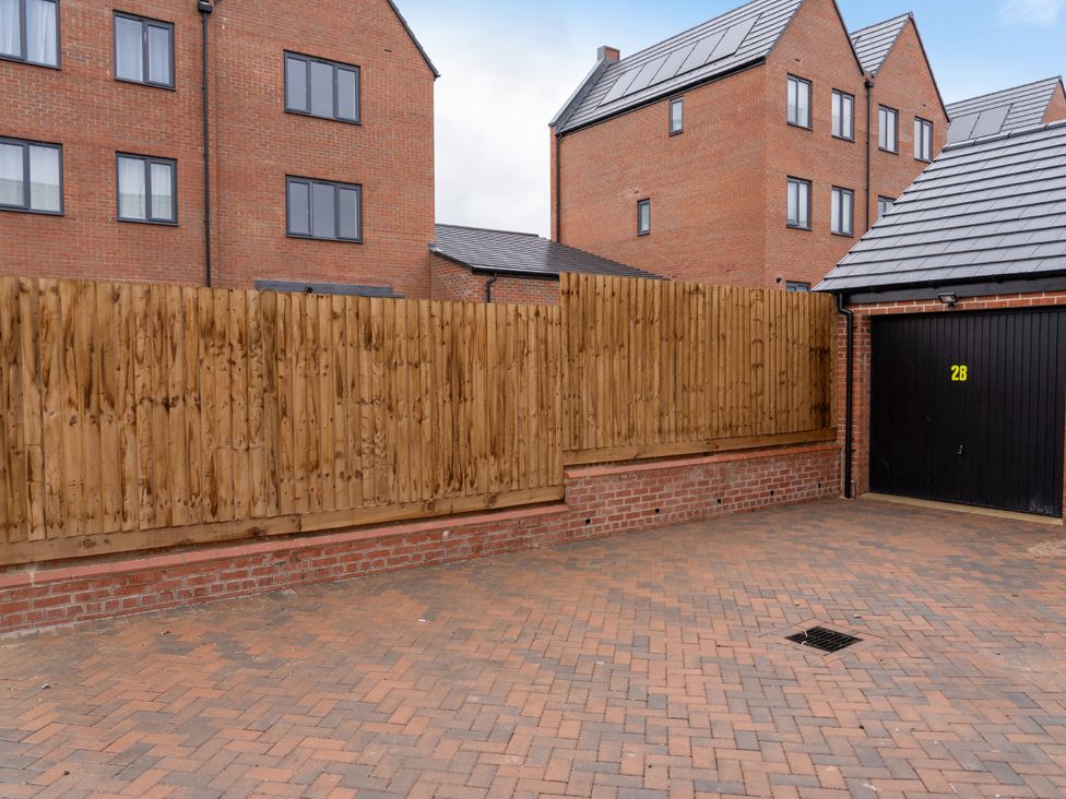 An outdoor area with a fence and garage door at Peak Avenue Retreat in Wingerworth near Chesterfield