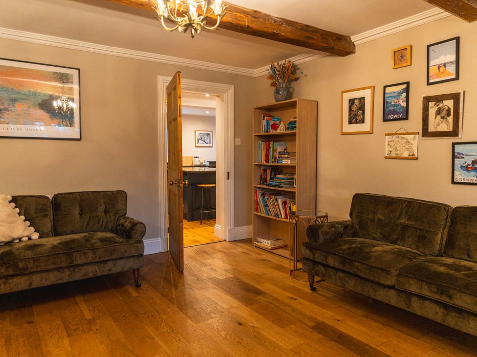 A living room with two sofas and a bookcase at Willow Garth in Roecliffe near Boroughbridge