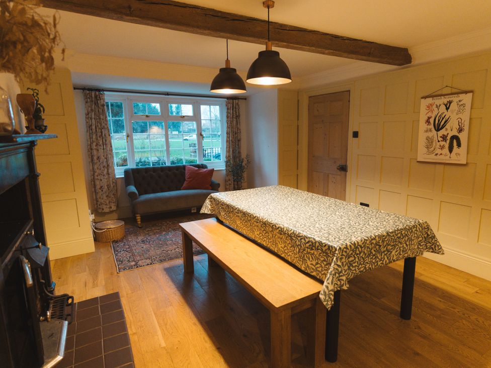 A dining room with a table and bench at Willow Garth in Roecliffe near Boroughbridge