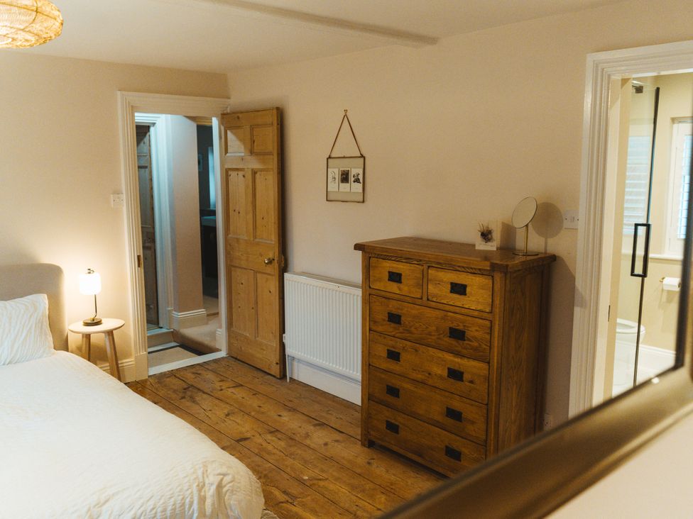 A bedroom with a bed and a dresser at Willow Garth in Roecliffe near Boroughbridge