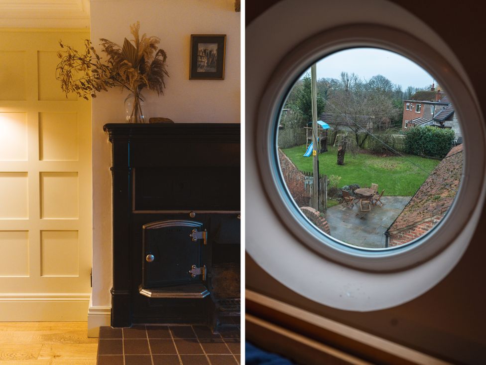 A living room with a door and stove and view of the garden at Willow Garth Roecliffe near Boroughbridge
