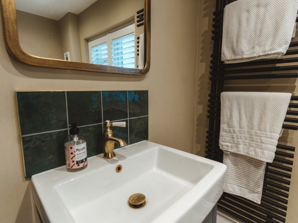 A bathroom with a sink and hand wash at Willow Garth Roecliffe near Boroughbridge