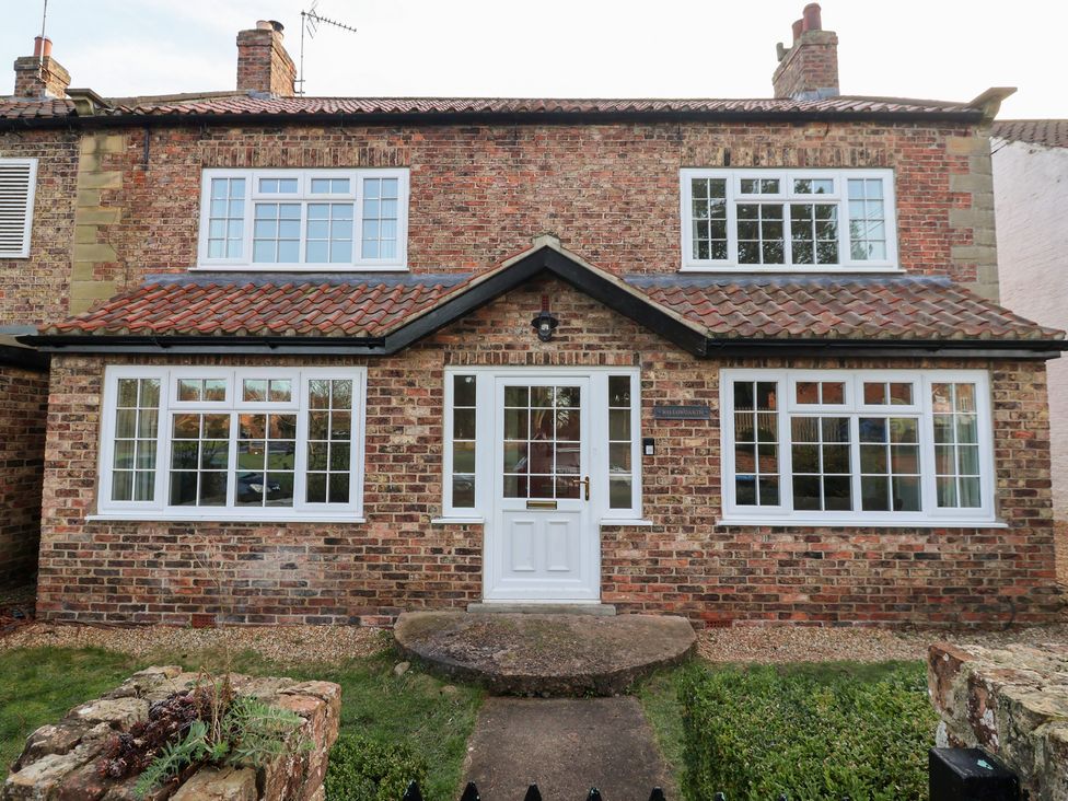 A brick house with multiple windows and a white front door at Willow Garth Roecliffe near Boroughbridge