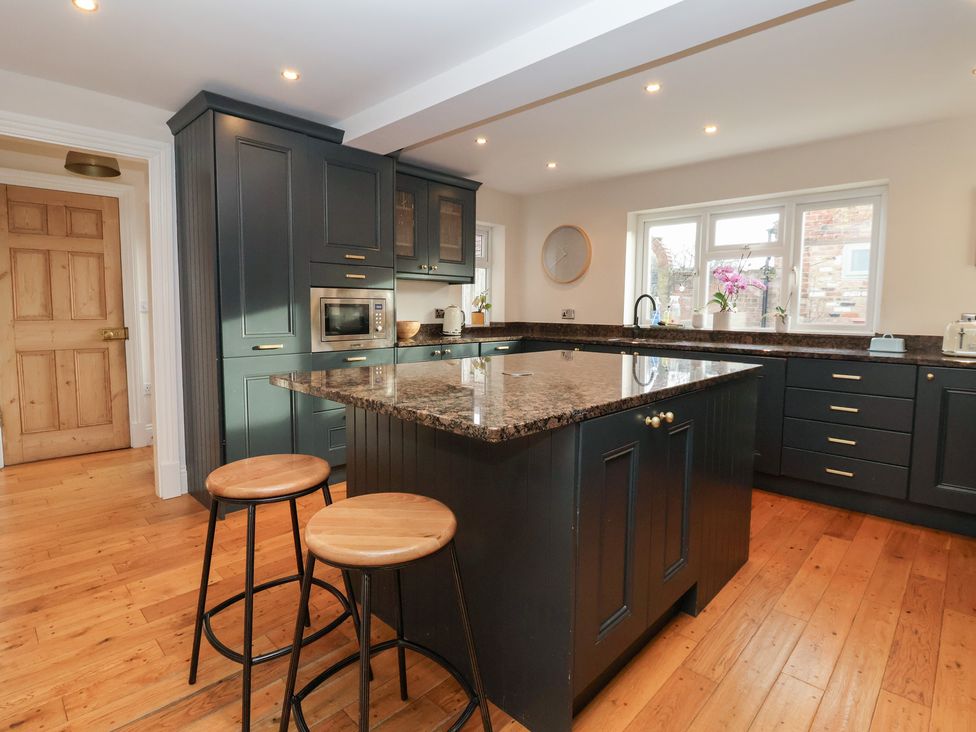 A kitchen with island and stools at Willow Garth in Roecliffe near Boroughbridge