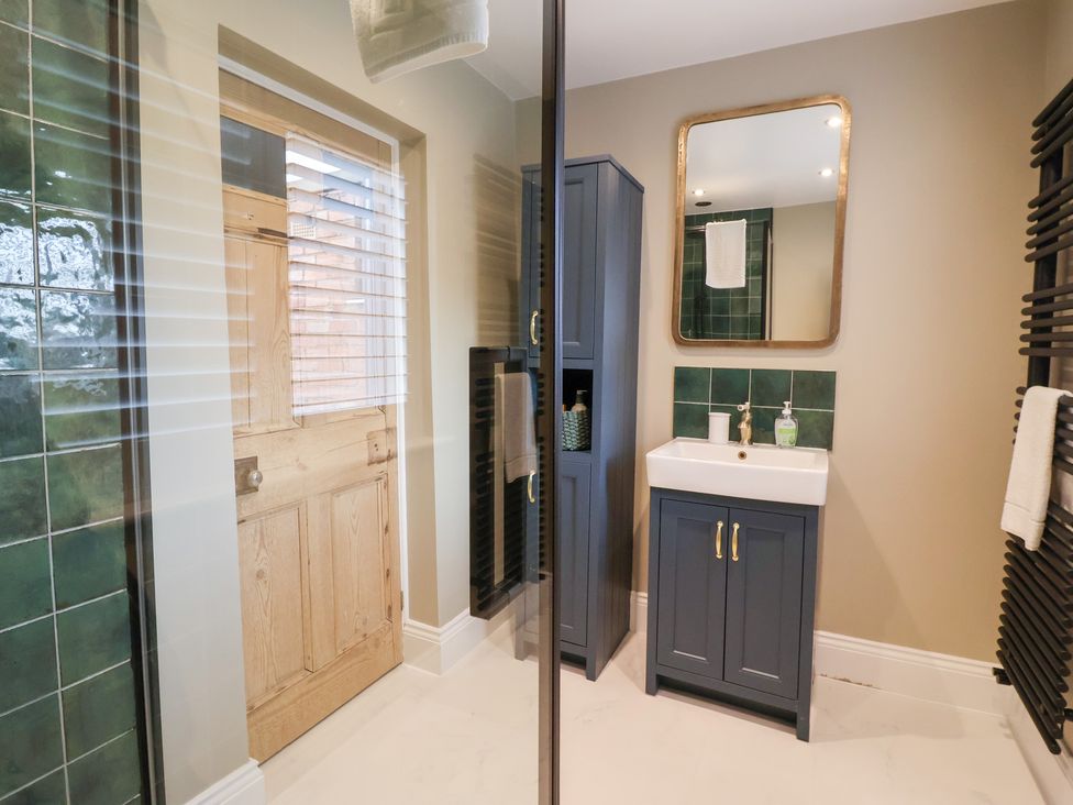 A bathroom with a shower and sink at Willow Garth in Roecliffe near Boroughbridge