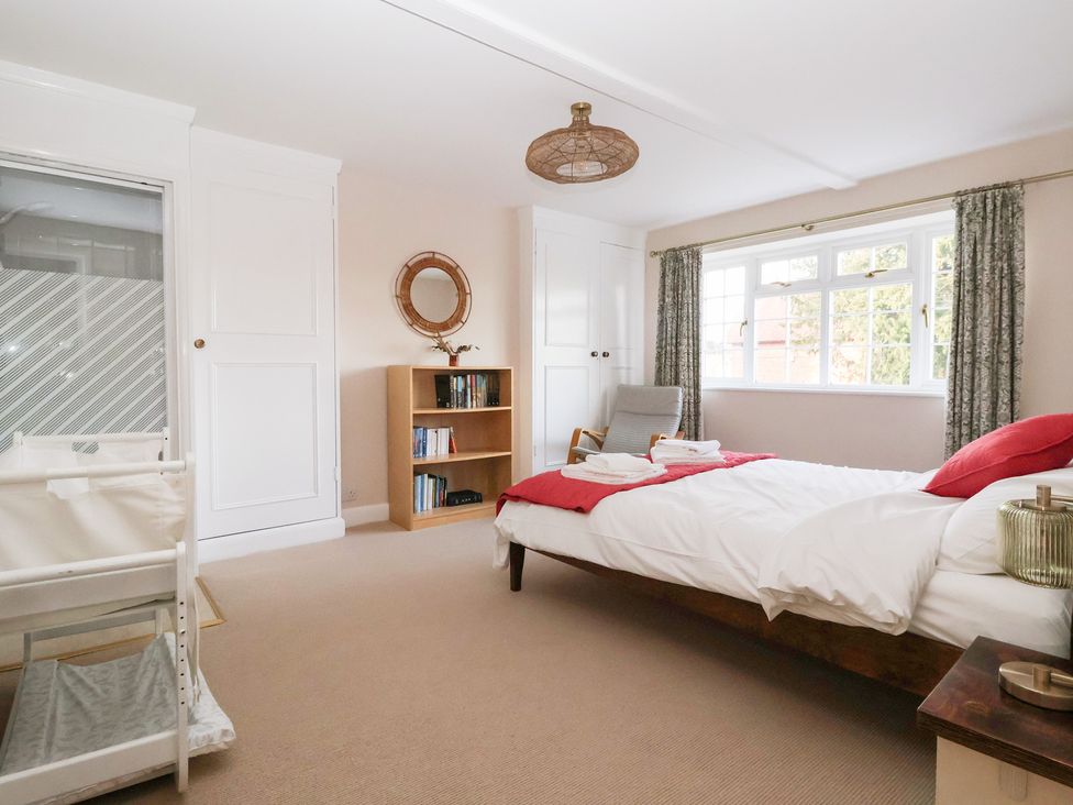 A bedroom with a bed and bookshelf at Willow Garth Roecliffe near Boroughbridge