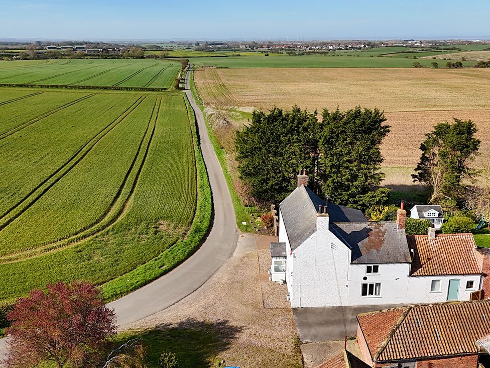An outdoor view of fields and a house at Bewholme, Skipsea