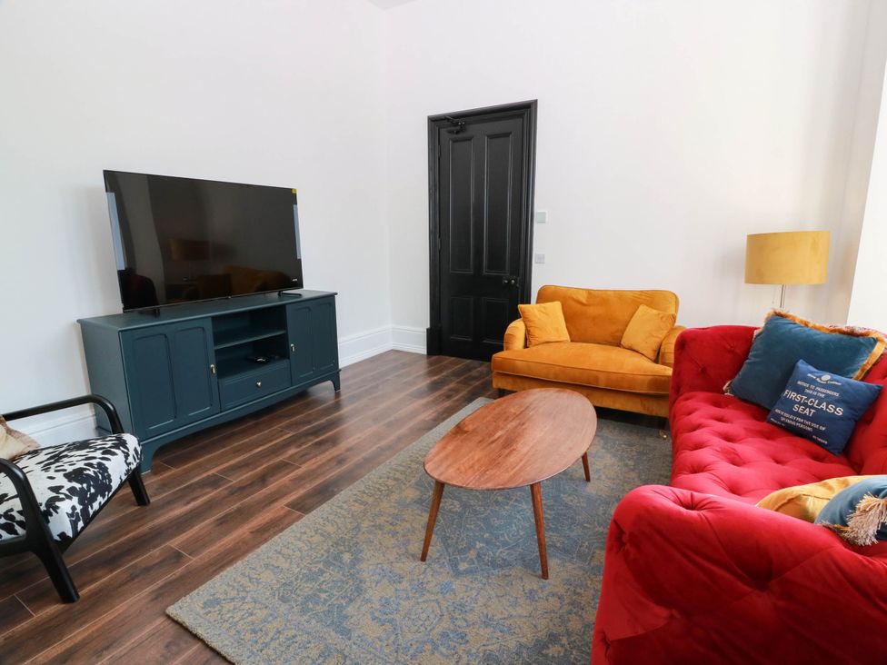 A living room with a television and sofas at Winnocklands House