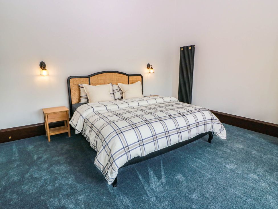 A bedroom with a bed and nightstand at Winnocklands House