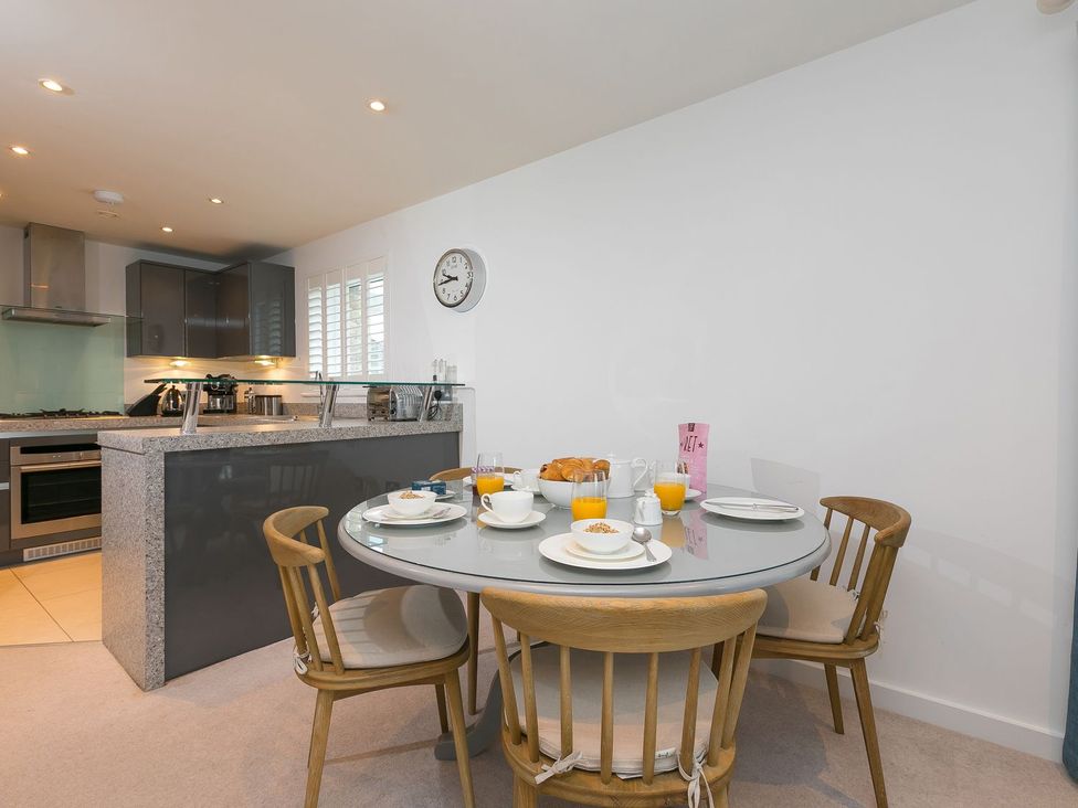 A kitchen with a dining table set for breakfast at Far Cliffs in St. Ives