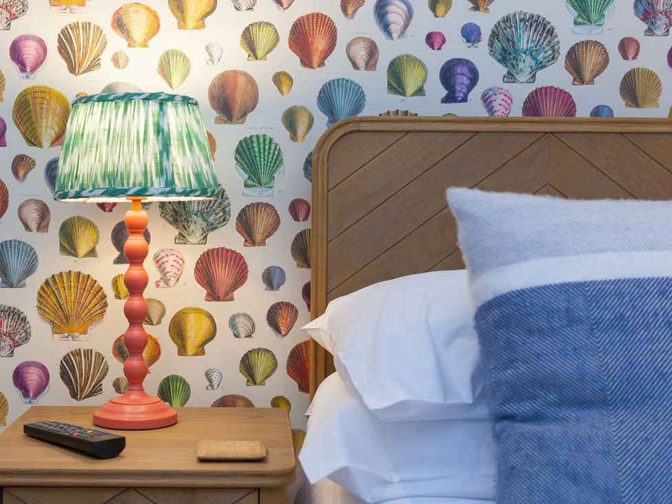 A bedroom with a bed and bedside table at Far Cliffs in St. Ives