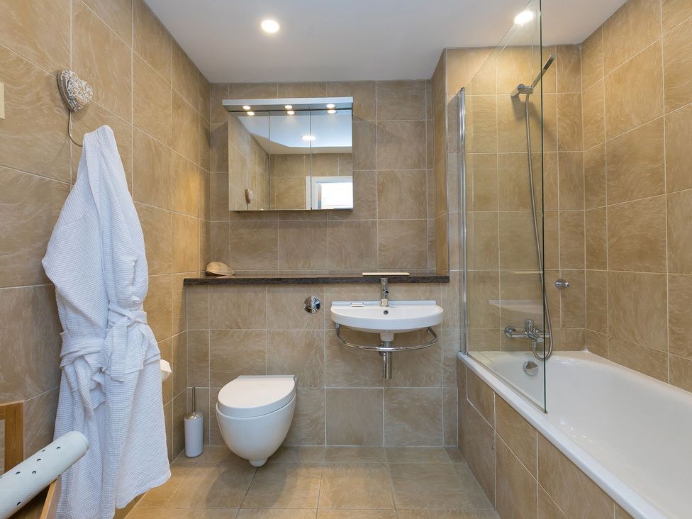 A bathroom with a bathtub, sink, and toilet at Far Cliffs in St. Ives