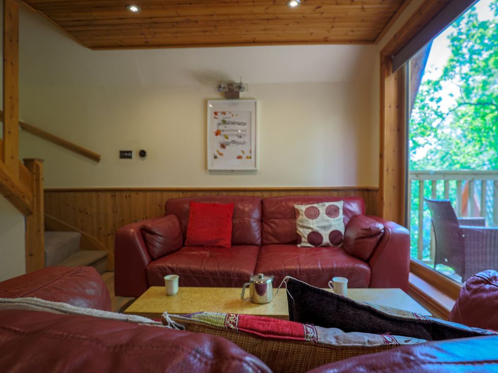 A living room with a sofa and coffee table at Lodge 68 - Fern Gully near Finlakes Holiday Park near Chudleigh