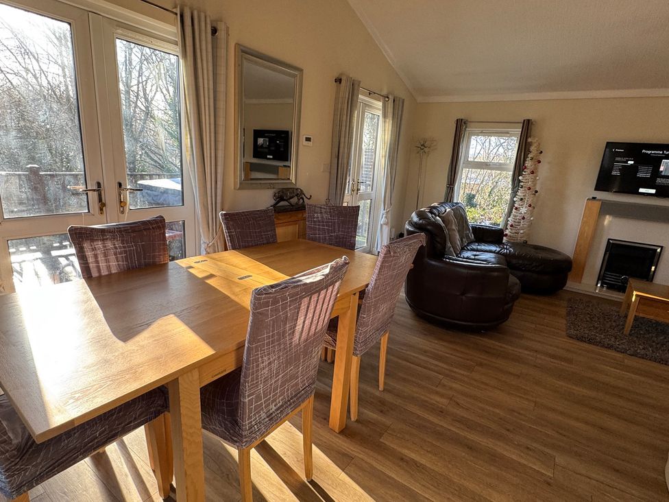 A living room with a dining table and a sofa at Woodland View 31 - The Hawthorns near Finlakes Holiday Park