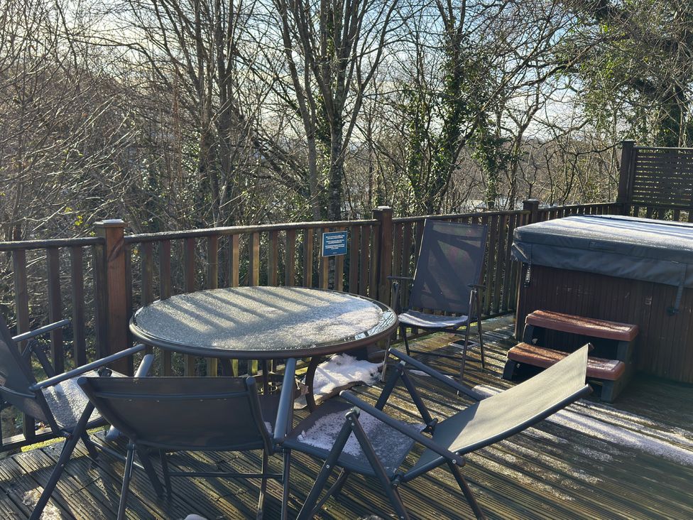 An outdoor seating area with a table and chairs at Woodland View 31 - The Hawthorns Finlakes Holiday Park near Chudleigh