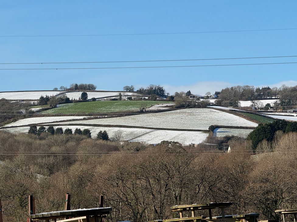 Snow-covered fields and trees at Woodland View 31 - The Hawthorns near Finlakes Holiday Park
