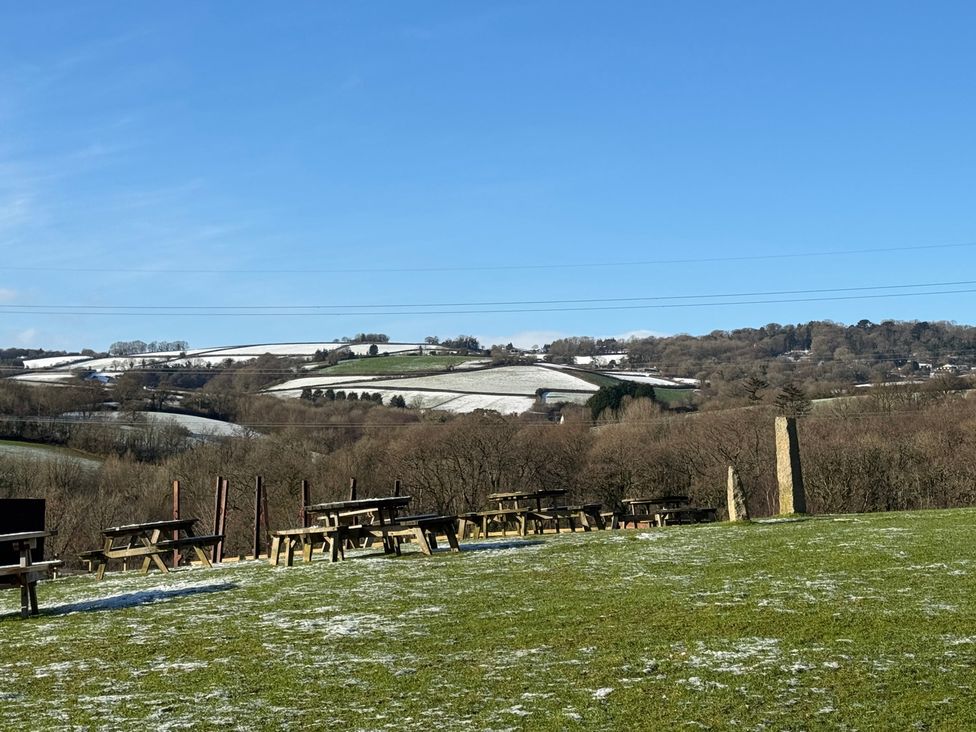 A view of tables and chairs in a snowy landscape at Woodland View 31 - The Hawthorns near Finlakes Holiday Park