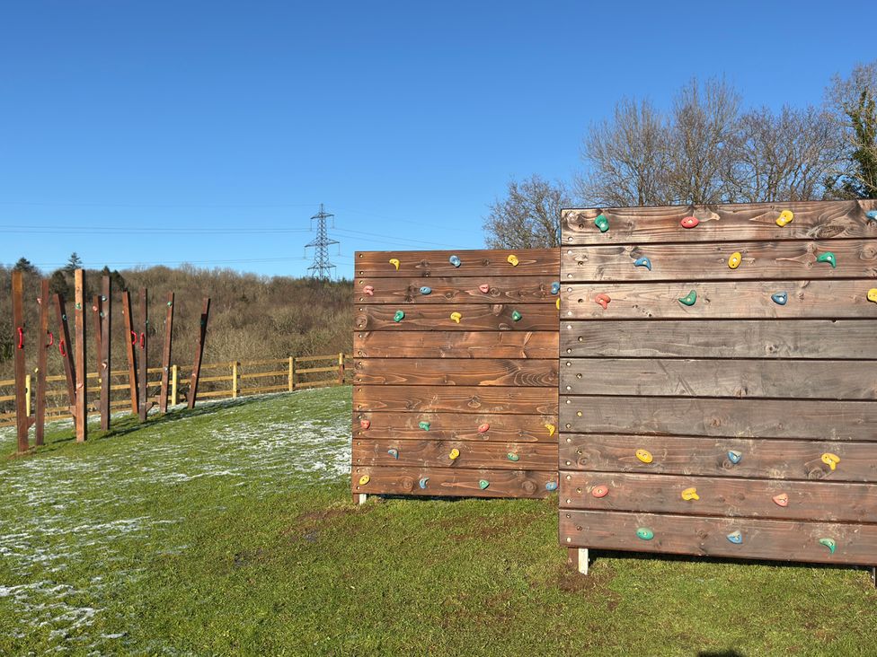 An outdoor climbing area with two climbing walls at Woodland View 31 - The Hawthorns Finlakes Holiday Park near Chudleigh