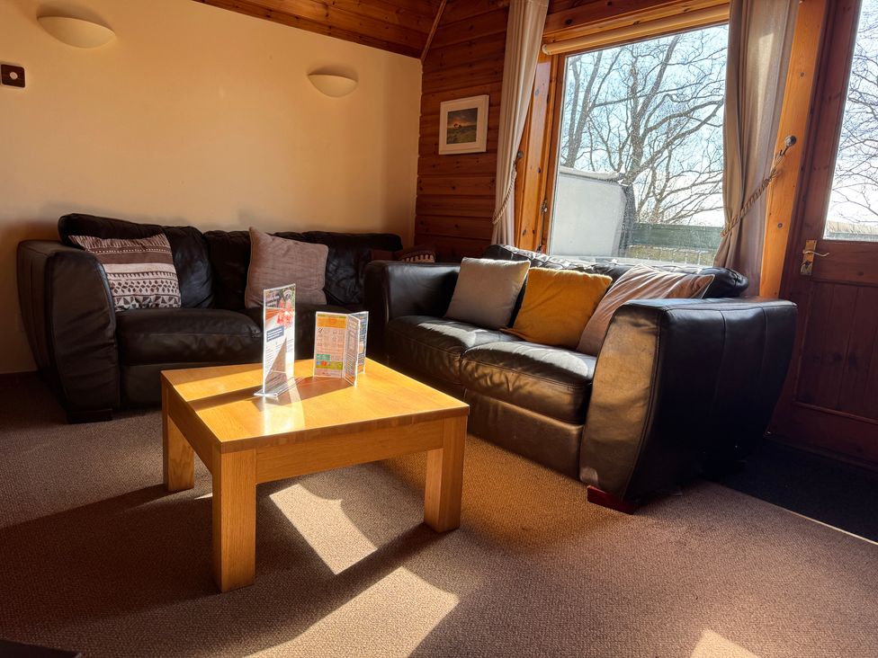 A living room with a sofa and coffee table at Tor View Finlakes Holiday Park near Chudleigh