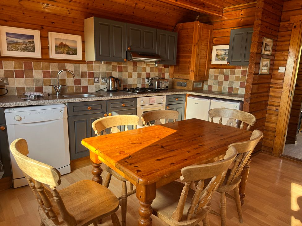 A kitchen with a wooden table and chairs at Tor View near Finlakes Holiday Park near Chudleigh