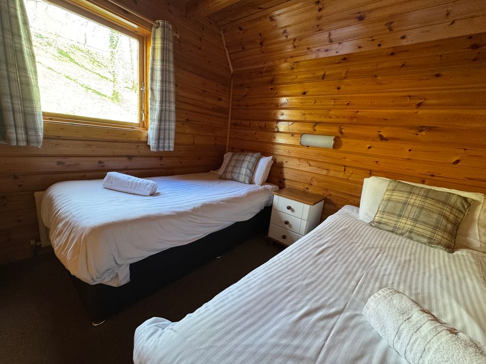 A bedroom with two beds and a window at Tor View Finlakes Holiday Park near Chudleigh