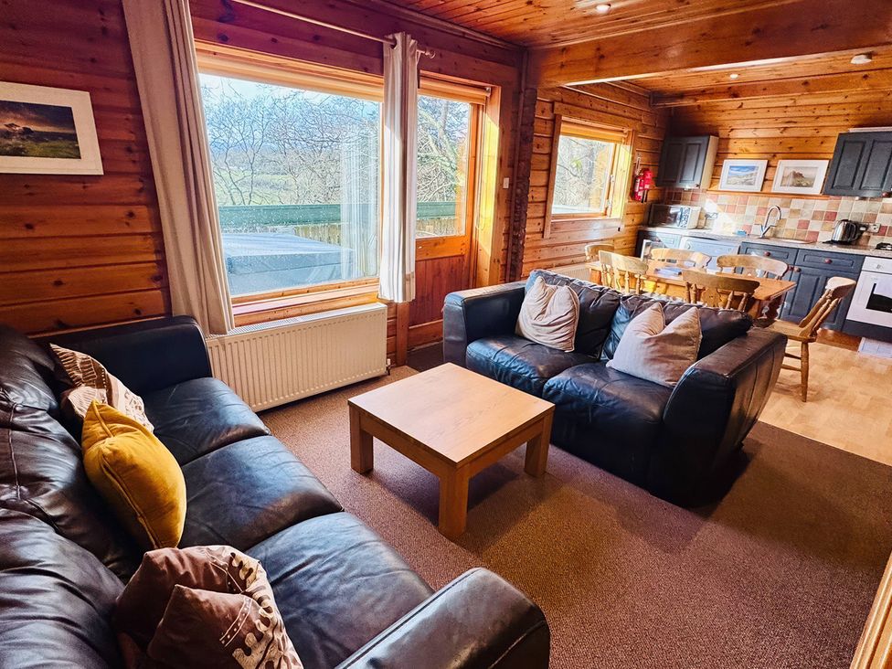 A living room with a sofa and dining area at Tor View Finlakes Holiday Park near Chudleigh