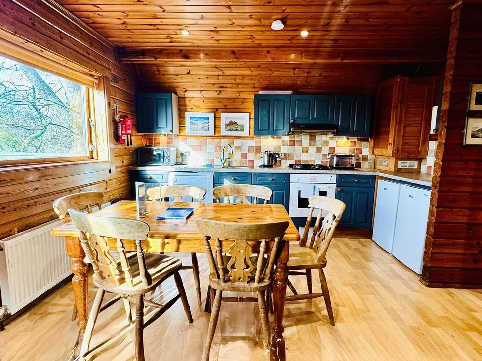 A kitchen with a table and chairs at Tor View, Finlakes Holiday Park near Chudleigh