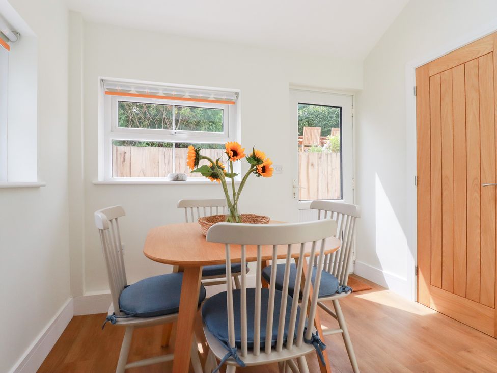 A dining room with a table and chairs at Glendale in Port Isaac