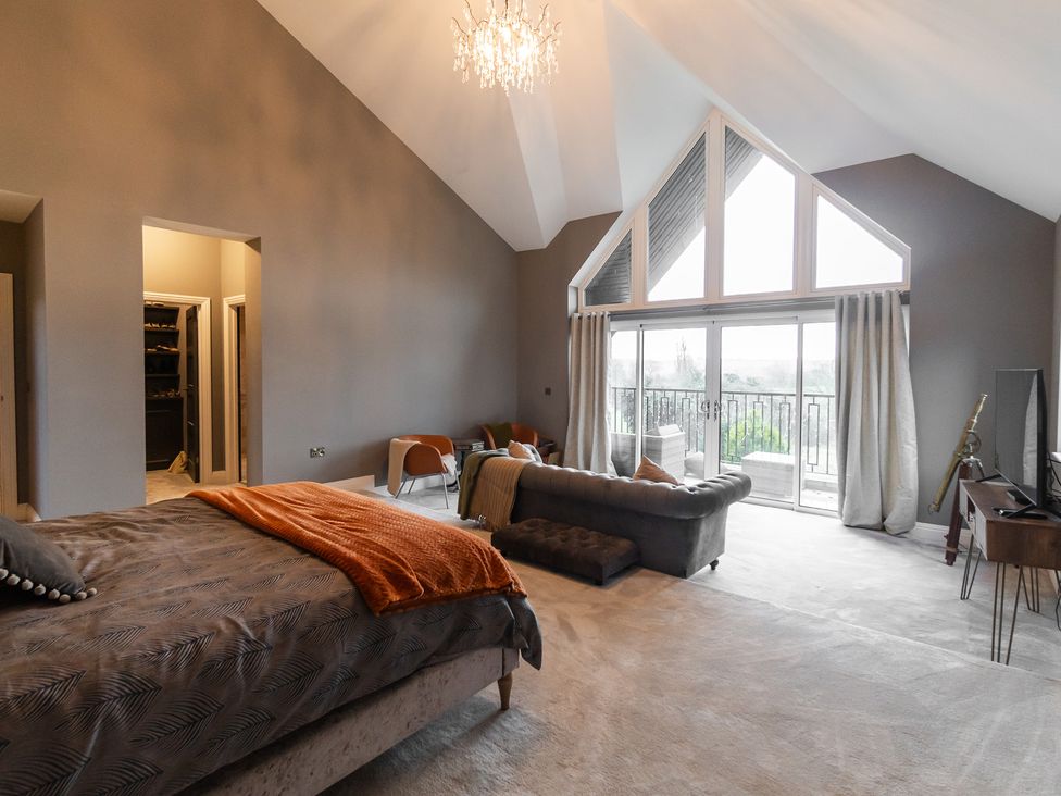 A bedroom with a bed and sofa at 30 High Lane East Ilkeston