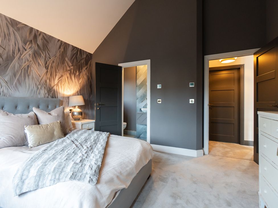 A bedroom with a bed and dresser at 30 High Lane East Ilkeston