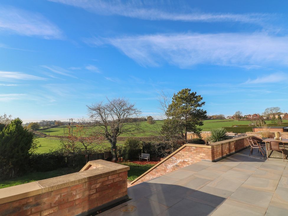 A garden with a view of the field and trees at Hallam Retreat in West Hallam