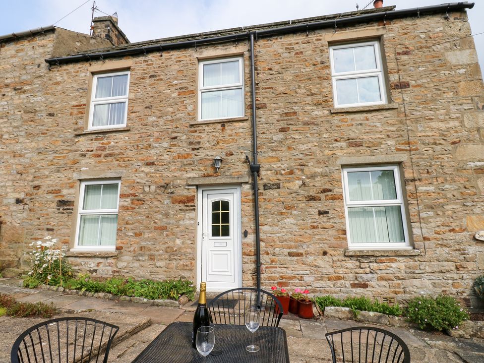 A stone building with windows and door at South View, Gunnerside near Reeth