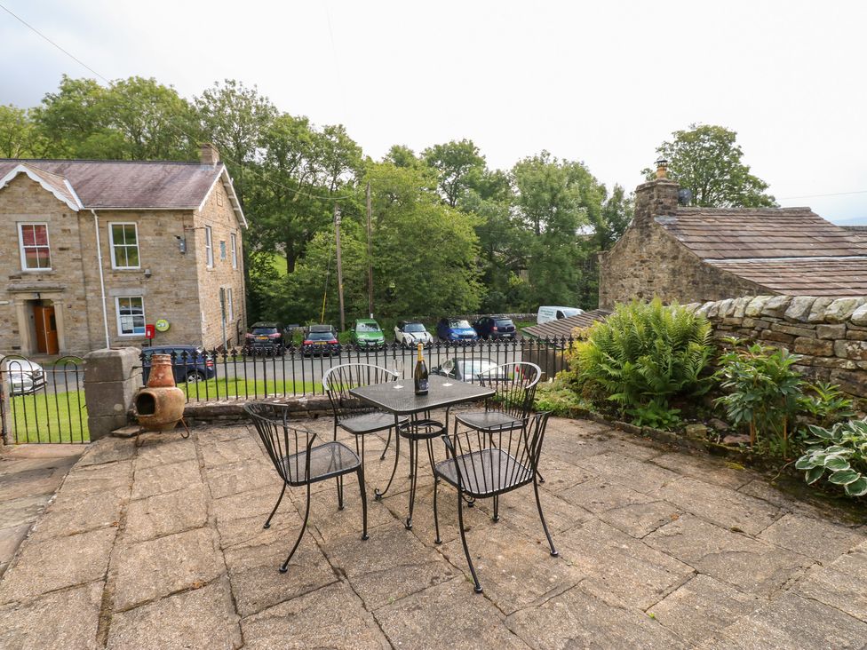 An outdoor seating area with a table and chairs at South View, Gunnerside near Reeth