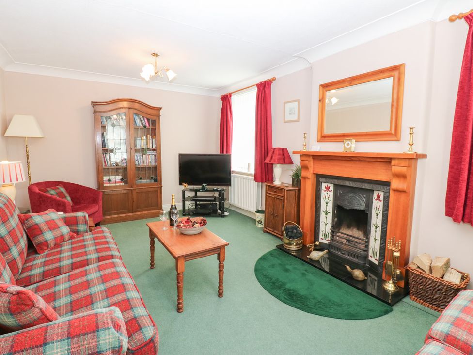 A living room with a sofa and armchair at South View, Gunnerside near Reeth