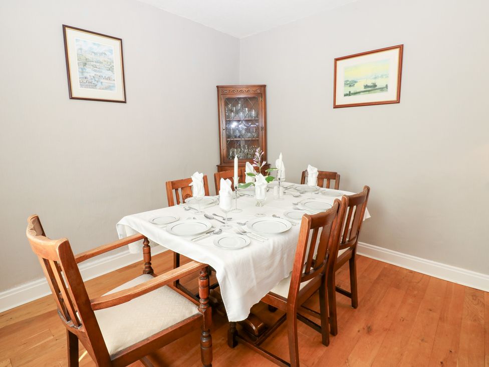 A dining room with a table set for dinner at South View, Gunnerside near Reeth