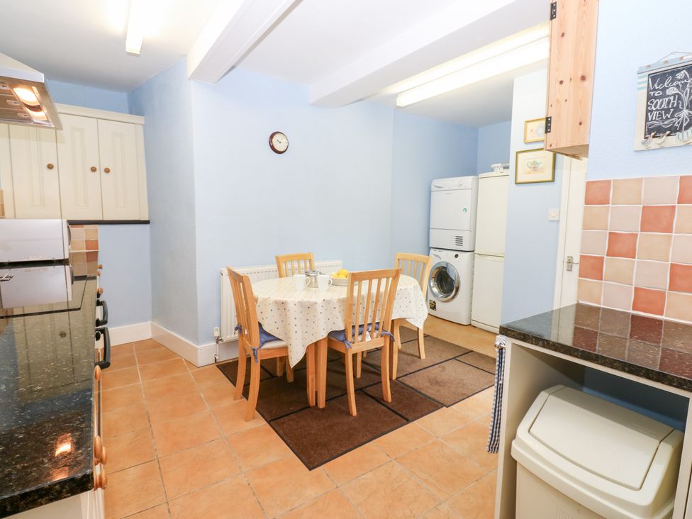 A kitchen with a dining table and chairs at South View, Gunnerside
