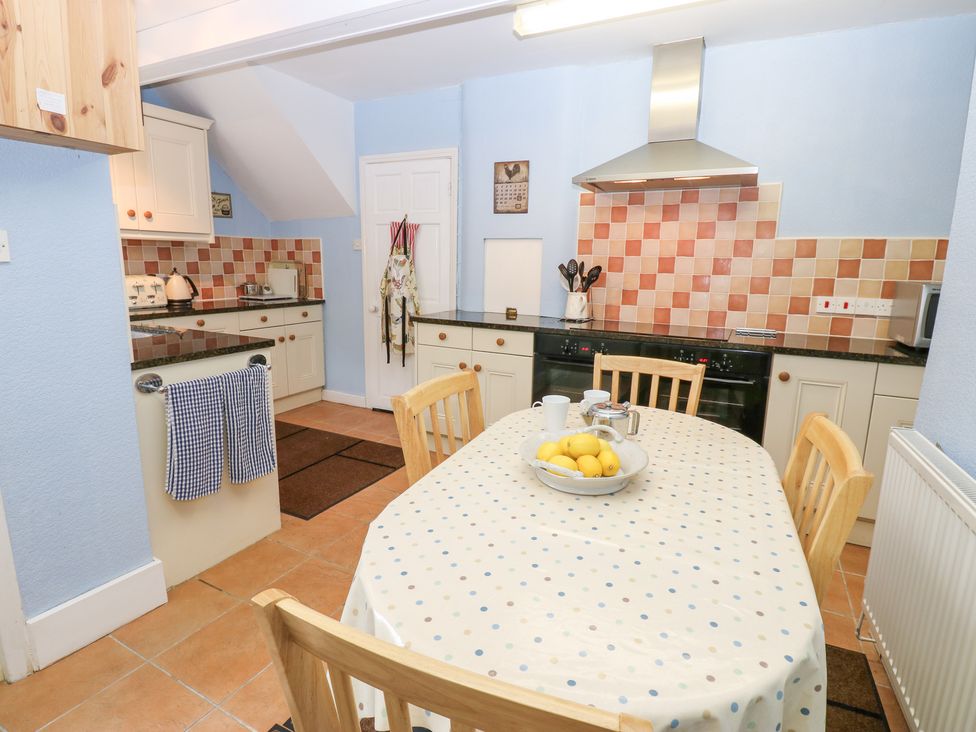 A kitchen with a dining table and chairs at South View, Gunnerside near Reeth