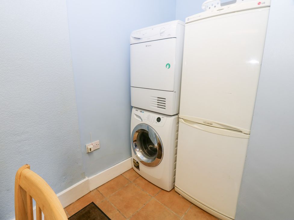A laundry room with a washing machine and dryer at South View, Gunnerside