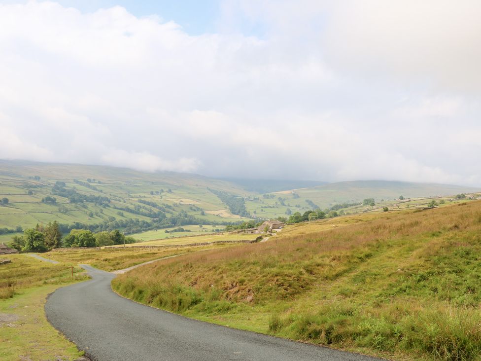 A winding road in a hilly landscape at South View, Gunnerside, Gunnerside near Reeth