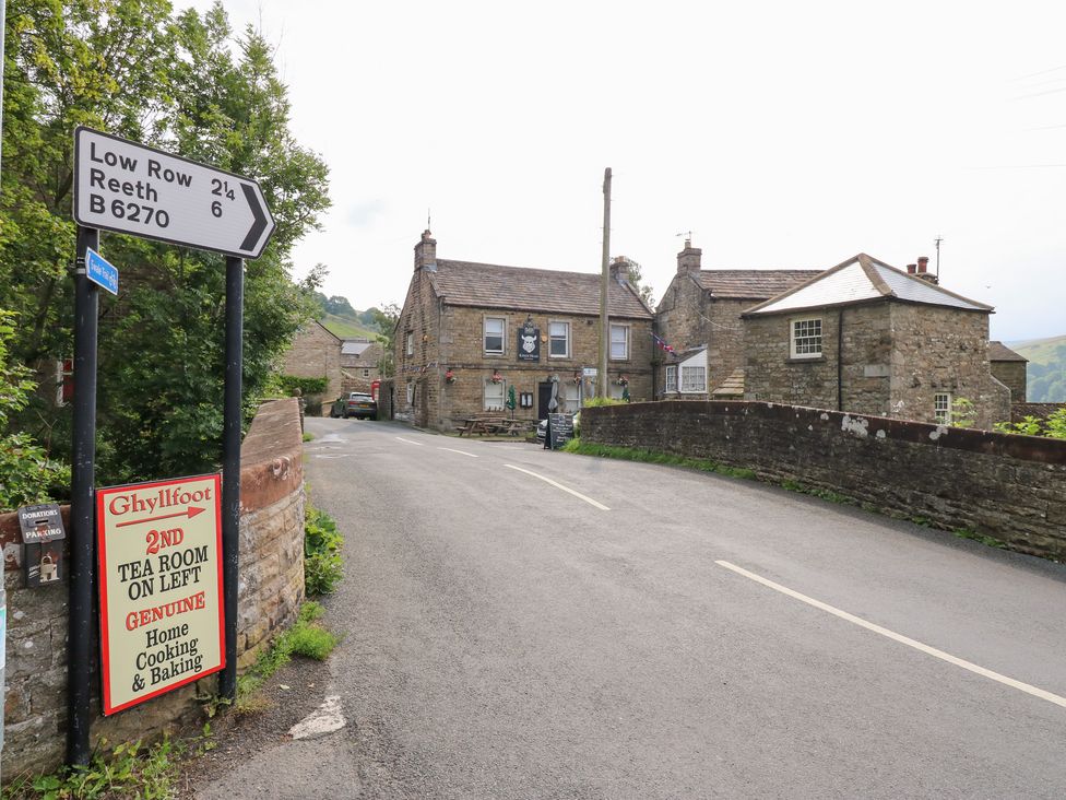 A road and buildings at Ghyllfoot in Gunnerside near Reeth
