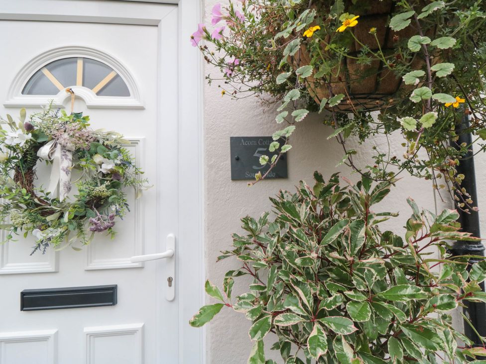 A door with a wreath and a sign at Acorn Cottage South Side