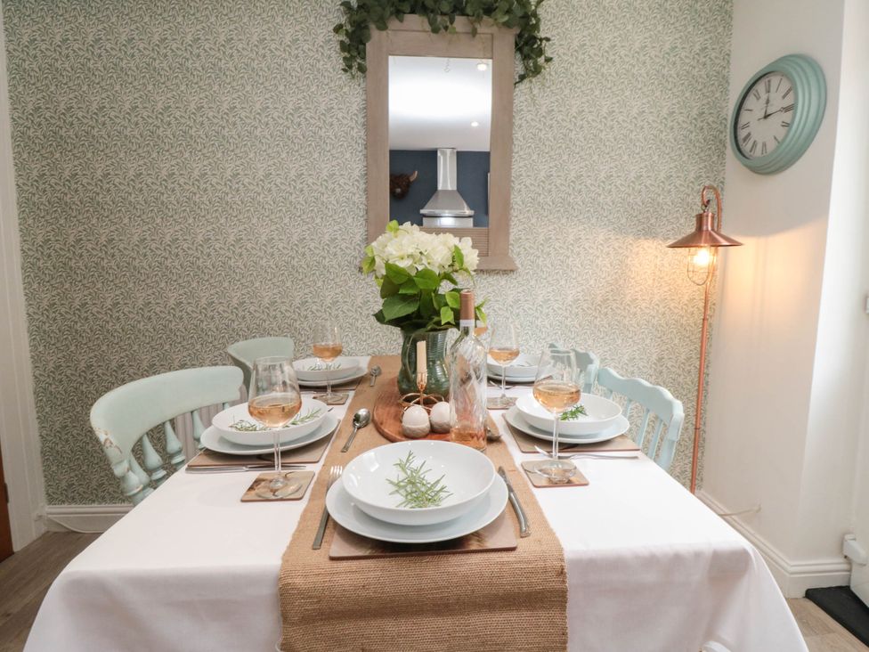 A dining room with a table set for a meal at 5 South Side
