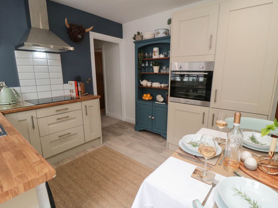A kitchen with cabinets, counter, and dining setup at 5 South Side