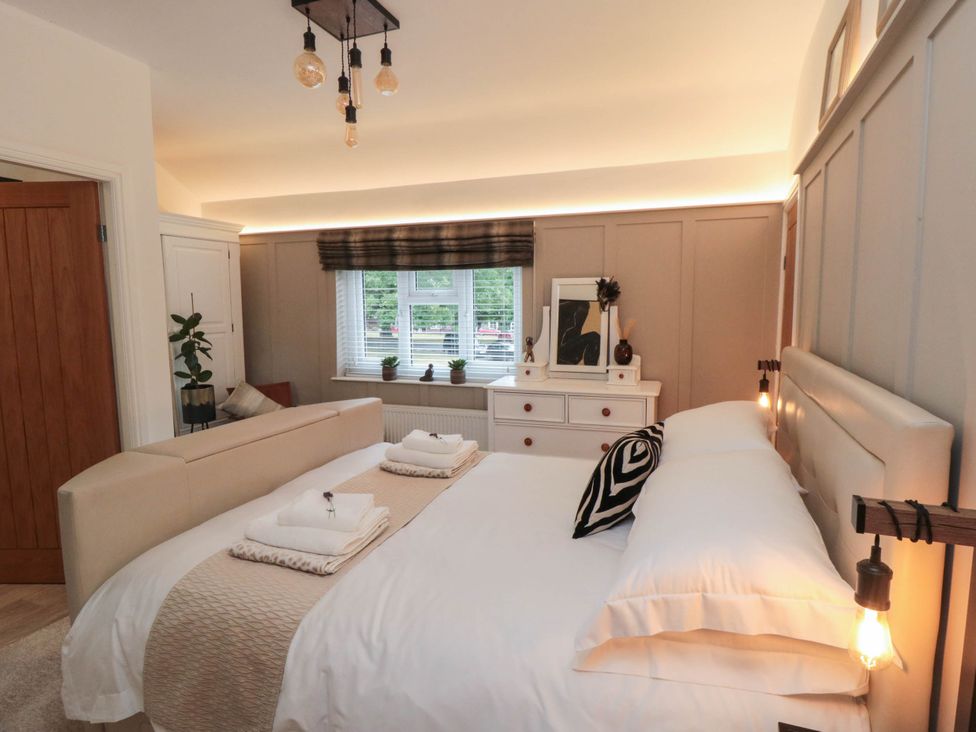 A bedroom with a bed and dresser at 5 South Side